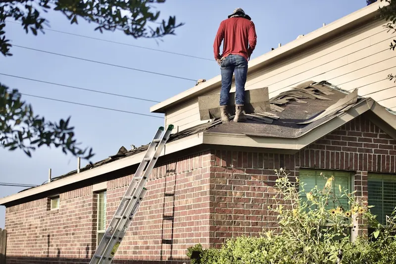 Professional roofer working on a residential roof in East Cambridge